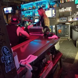 a cowpony bar with a man working on a laptop