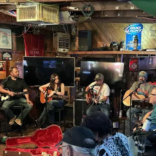 a group of people playing guitars