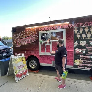 a man standing in front of a food truck