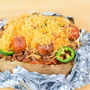 a baked potato topped with cheese and chili