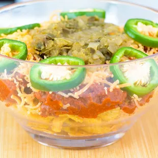 Classic Frito pie topped with Sloppy Eddie chili, shredded cheddar cheese, raw onions, and raw jalapeños.