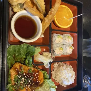 a bento tray with a variety of food items