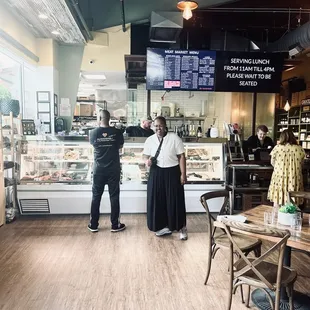 two people standing in front of the counter