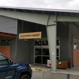 a blue truck parked in front of the building