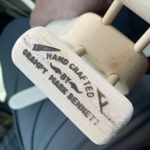 a person holding a wooden rocking chair