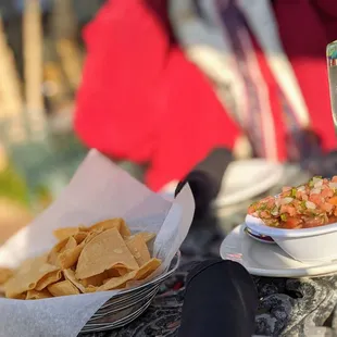 a plate of chips and a bowl of salsa