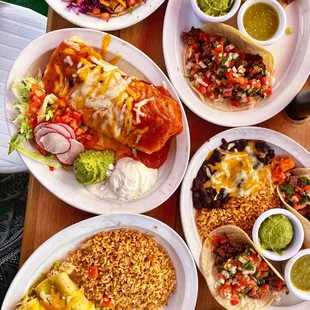 Chicken enchiladas with green sauce, shrimp tacos, carne asada tacos, veggie burrito