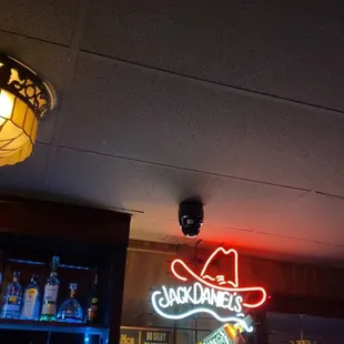 a neon sign above a bar