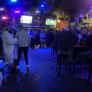 a crowd of people at a bar