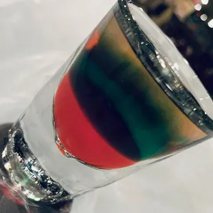 a colorful drink in a tall glass
