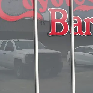 a car parked in front of a bar