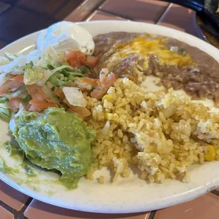 Each person gets their sides. Rice guacamole refried beans and sour cream.