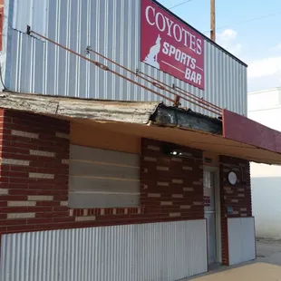 the corner of a building with a sign on it