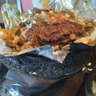 This delicious dish was served in a molcejete (bowl made of mortar), shrimp, chicken, beef, pork, chorizo &amp; veggies!