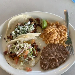 a plate of food with rice, beans, and beans