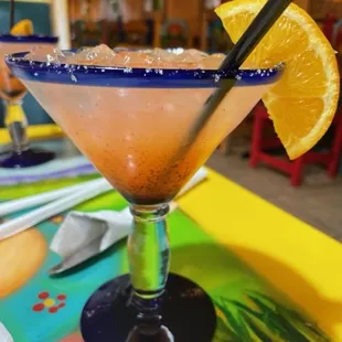 a margarita with a slice of orange
