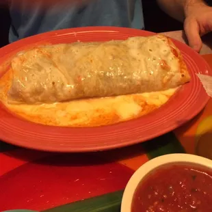 Huge burrito with cheese sauce
