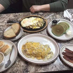 Country omelette, biscuits and gravy, bacon, country hash, green pancakes