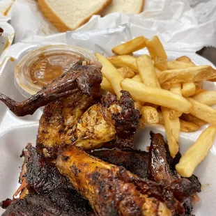 Two ribs, two wings with baked beans and French fries