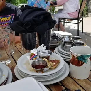 a man sitting at a table with plates of food