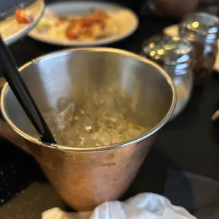 a bowl of soup with chopsticks in it