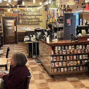 a woman sitting at a table in a restaurant