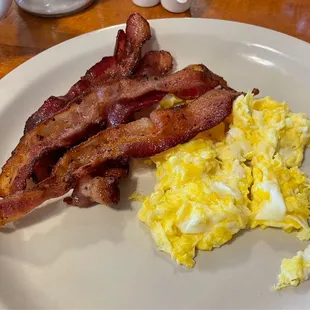 Side of bacon and two scrambled eggs