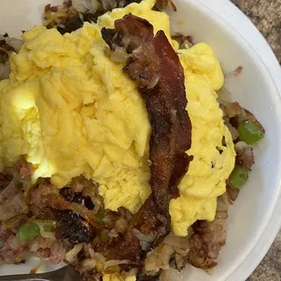 Corned beef hashbrown skillet showing the strip of pork bacon that was buried inside
