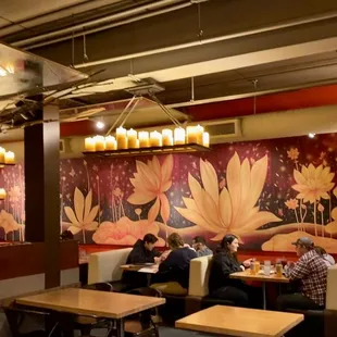 people sitting at tables in a restaurant