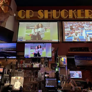 people watching televisions in a sports bar