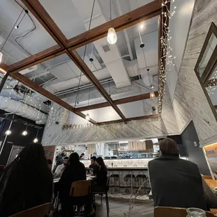 people sitting at tables in a restaurant