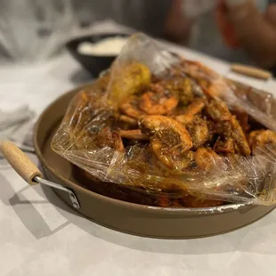 a plate of food wrapped in plastic