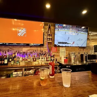 a bar with a large screen tv