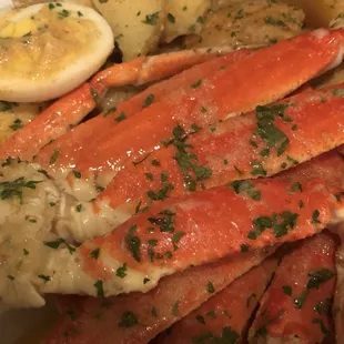 a plate of crab legs and potatoes