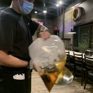 a man wearing a face mask and holding a bag of food