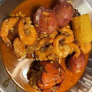 Shrimp, lobster tail, corn, and potatoes