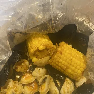 Clam &amp; black mussels boil with corn with garlic butter sauce, mild seasoning.