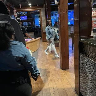 a woman walking through a restaurant