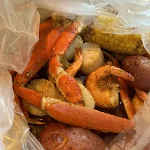 Crab legs. Scallops. Shrimp. Corn on the cob. Red potatoes. In a lemon pepper and Cajun mild sauce.