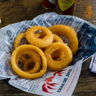 onion rings on a napkin with a fork and knife