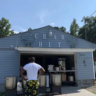 a man standing in front of a crab hut