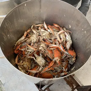a large metal bowl full of crabs