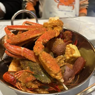 King crab leg, snow crab cluster, head-on shrimp, crawfish, mussels, clams, corn on the cob, potatoes, &amp; sausage