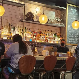 a group of people sitting at a bar