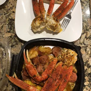 crab legs and potatoes in a pan