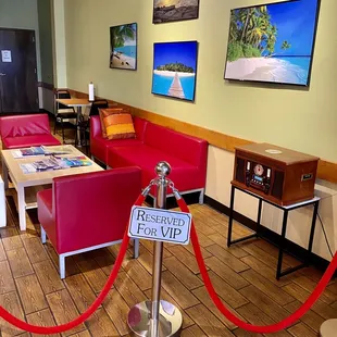 a restaurant with red chairs and a red rope