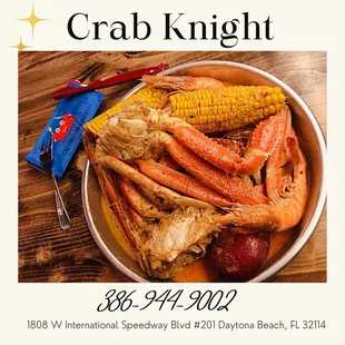 a bowl of crab legs, corn and potatoes