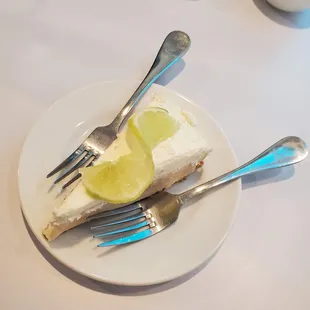 a slice of cheesecake and two forks
