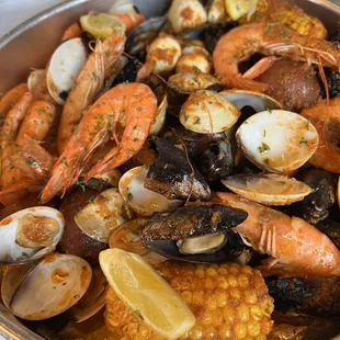 Seafood platter with shrimp, muscles, clams, corn and potatoes