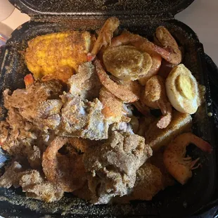 Neck bones shrimp potatoes and corn